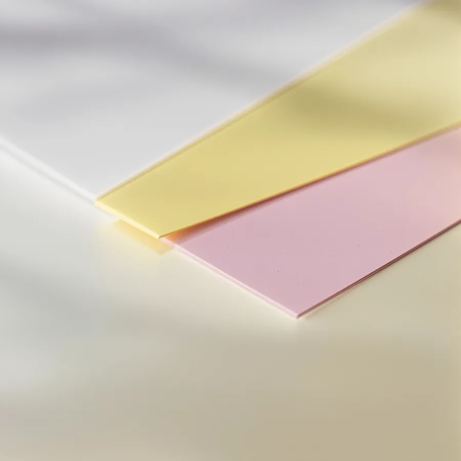 A 3-part carbonless form set fanned to show the white, canary and pink plies